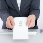 Person handing in a resignation letter when changing jobs in Japan